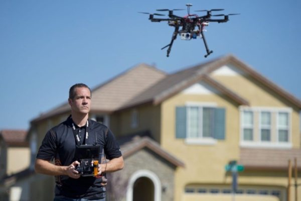 Christopher Brown, co-owner of Next New Homes Group, uses his multi-rotor helicopter drone to take aerial video of a home in Sacramento, Calif., on February 25, 2014. Drones are increasingly being used by small companies to shoot videos for real estate, car commercials, weddings, sports events, and other instances where aerial shots are needed. (Randy Pench/Sacramento Bee/MCT)